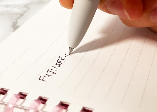 close up of jetstream lite touch ink ballpoint pen writing on a campus notebook