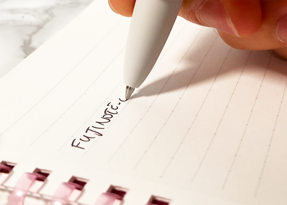 close up of jetstream lite touch ink ballpoint pen writing on a campus notebook